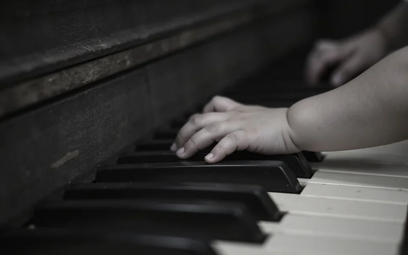 A young child's hands on piano keys